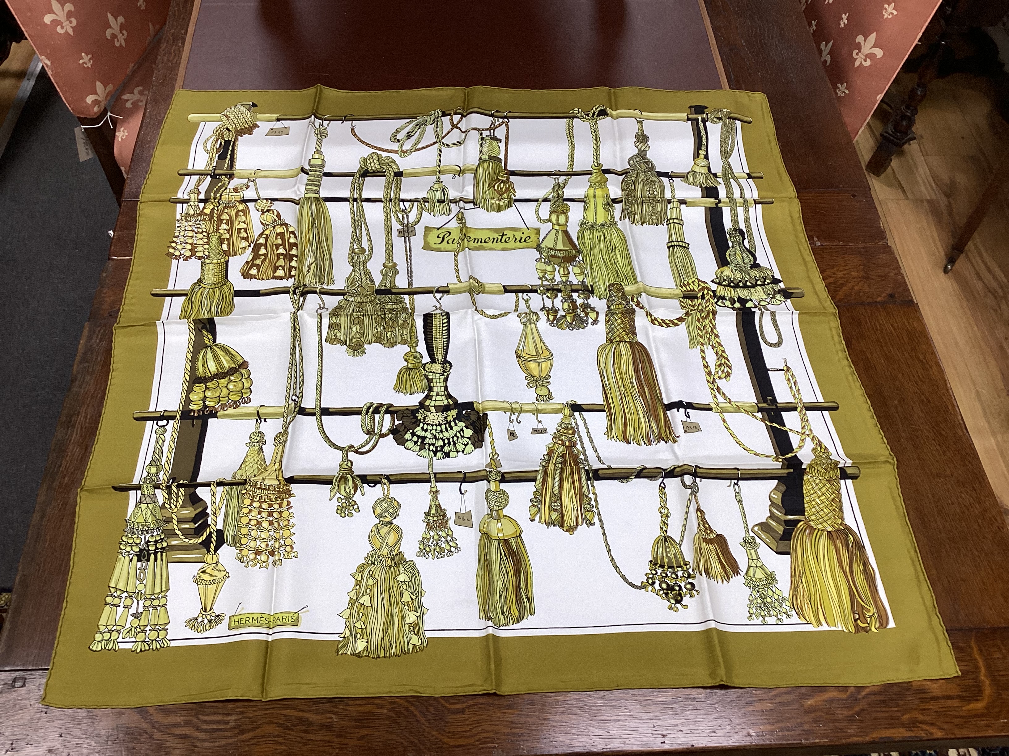 Four vintage Hermes silk scarves including one retailed by Harrods comprising, Selles A Housse, Roues de Canon, Passementerie and a rectangular Brides de Gala example